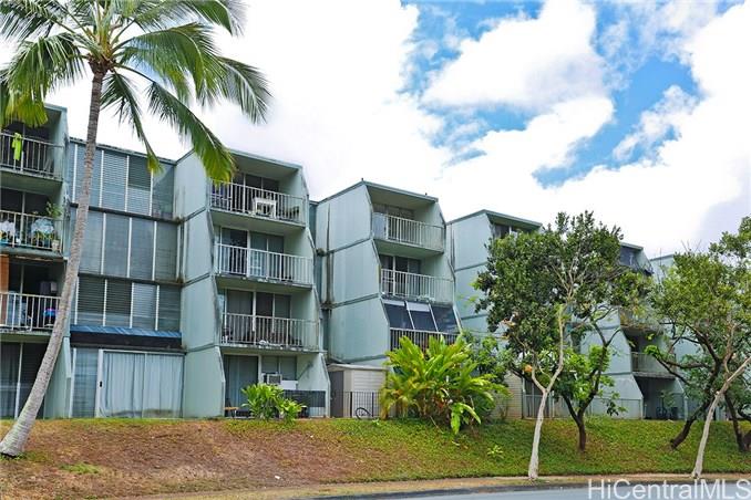 95-009 Waihonu Street, Unit A405 Mililani, HI 96789 - Photo 1 of 1 a front view of a residential apartment building with a yard
