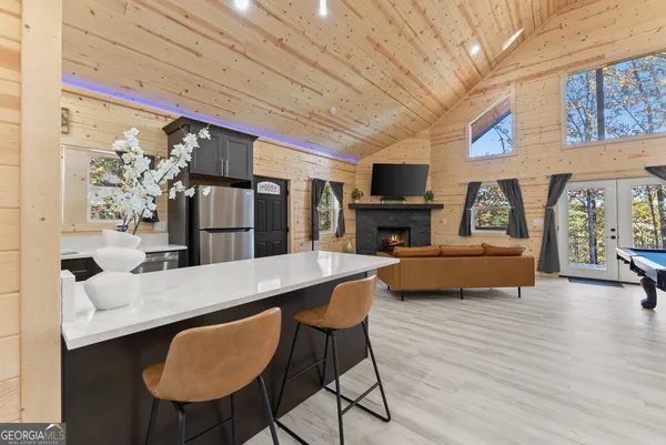 a living room with furniture a fireplace and a flat screen tv