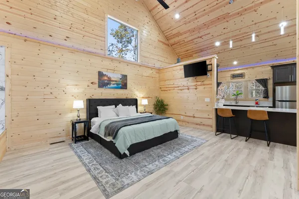 a spacious bedroom with a bed and a walk in closet
