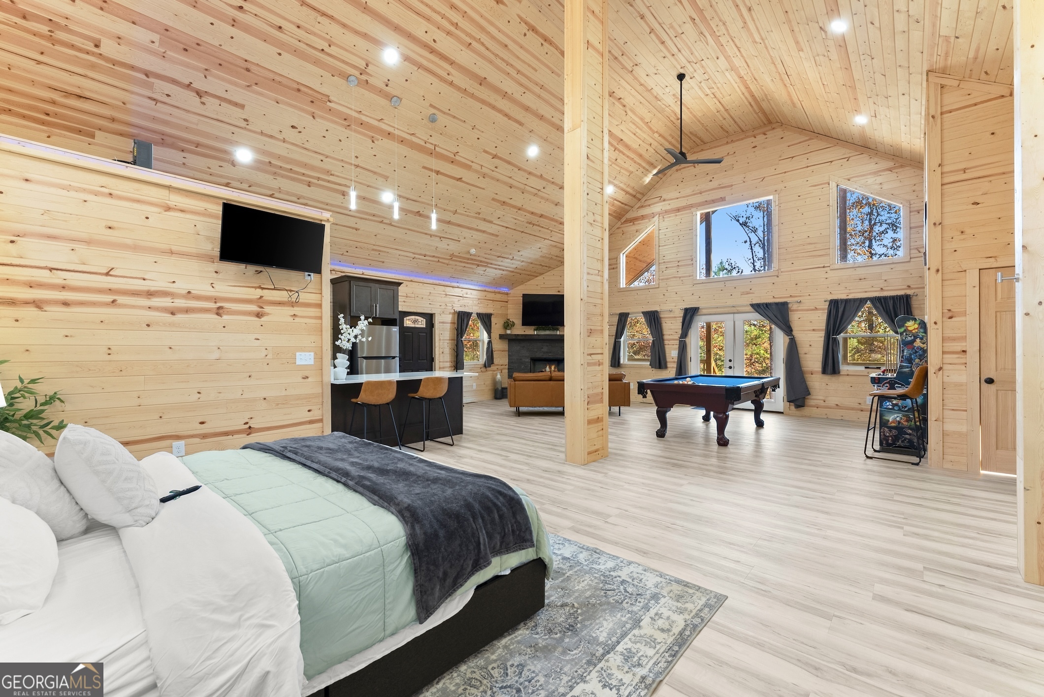 339 Hickory Ridge Drive Cleveland, GA 30528 - Photo 16 of 54 a bedroom with a bed a table and painting on the wall