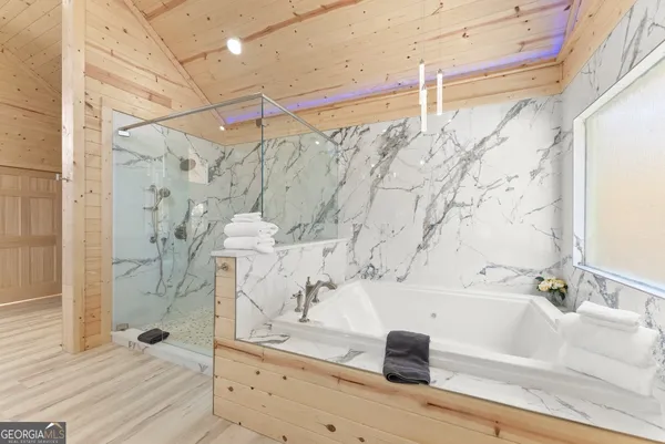 a bathroom with a bathtub and shower