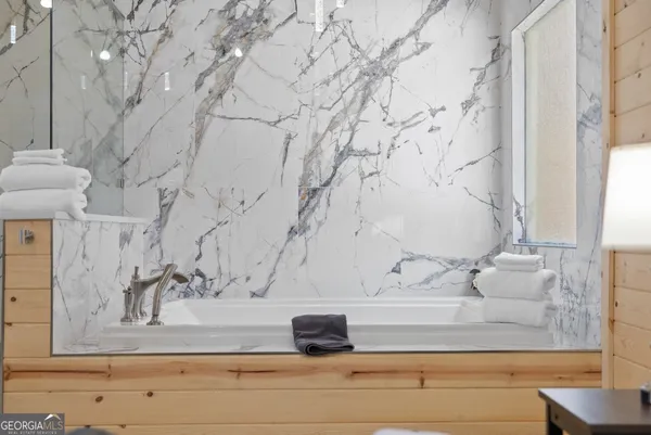 a view of a bathroom with a bathtub and a window