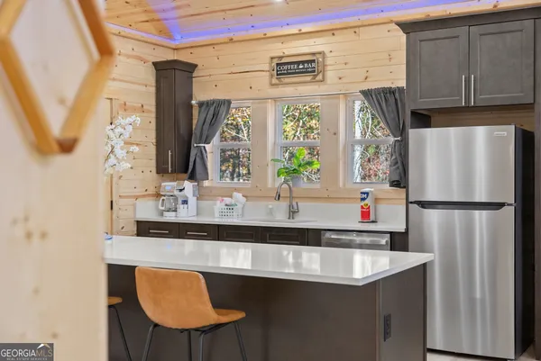 a kitchen with stainless steel appliances a sink and a large window