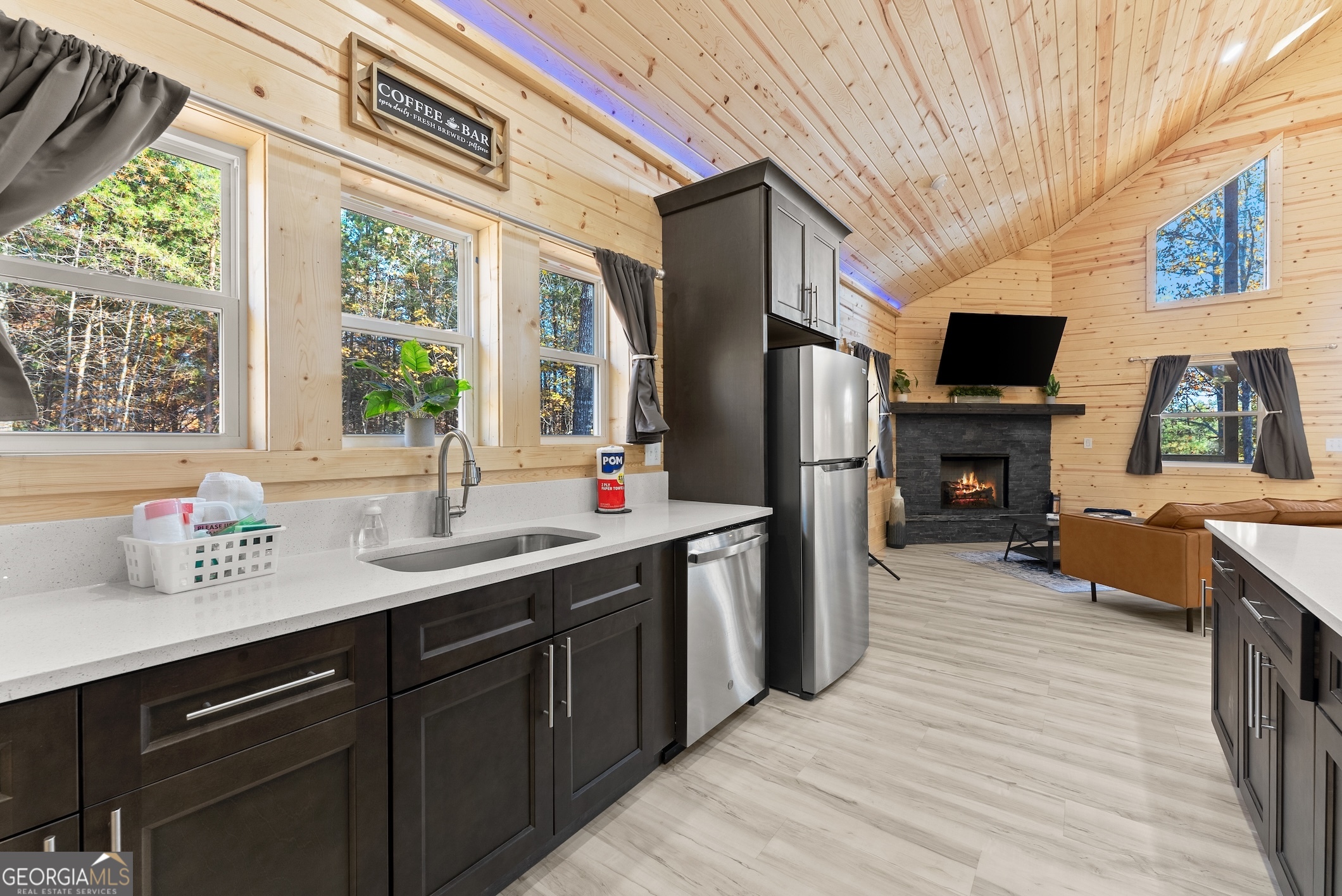 339 Hickory Ridge Drive Cleveland, GA 30528 - Photo 7 of 54 a kitchen with stainless steel appliances a sink dishwasher a refrigerator white cabinets and wooden floor