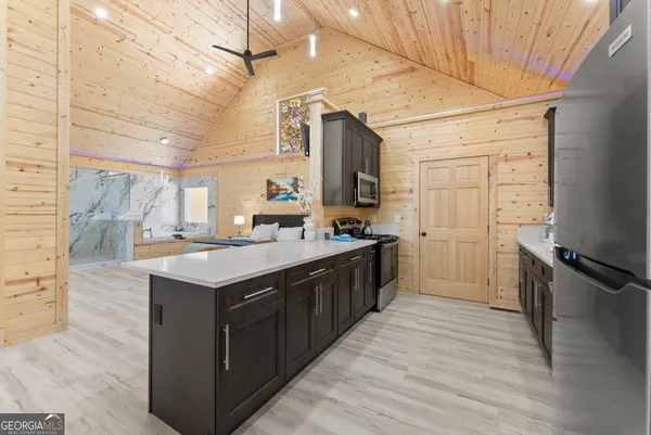 a kitchen with stainless steel appliances granite countertop a sink stove and refrigerator