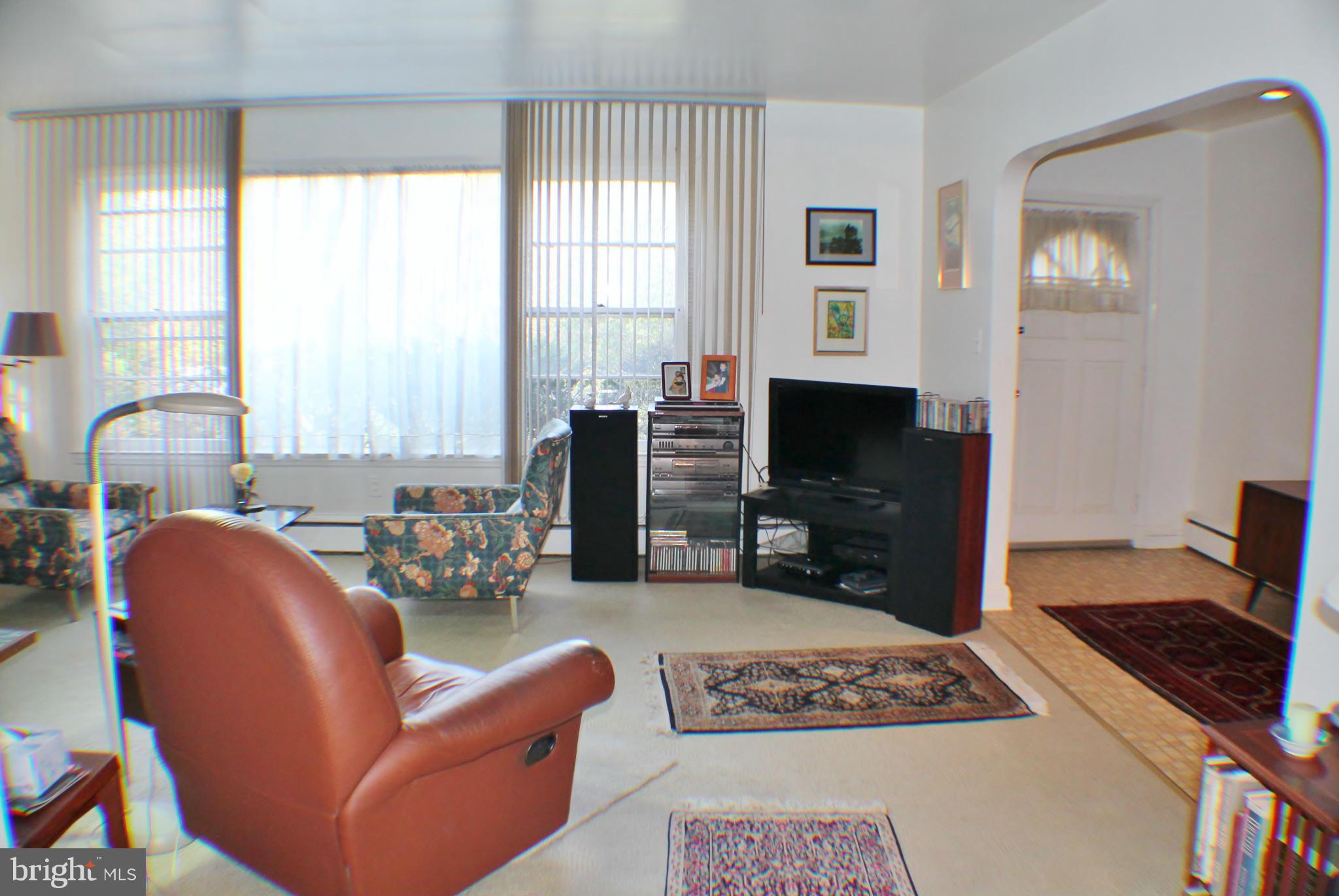 7205 Prince George Road Pikesville, MD 21207 - Photo 4 of 20 a living room with furniture and a flat screen tv