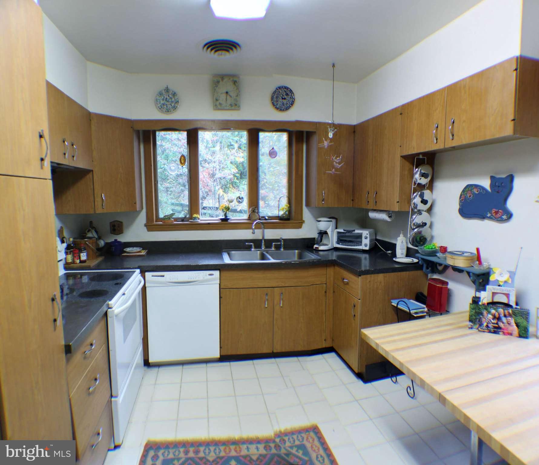 7205 Prince George Road Pikesville, MD 21207 - Photo 7 of 20 a kitchen with granite countertop a sink stove and cabinets