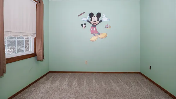 an empty room with windows and closet