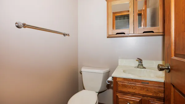 a bathroom with a sink a toilet and mirror