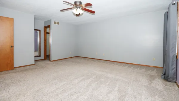a view of a livingroom with a dishwasher and a window