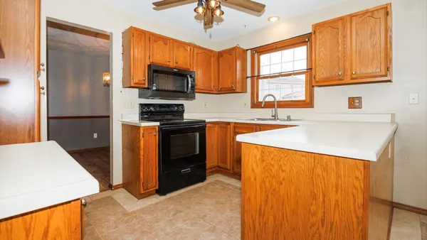 a kitchen with stainless steel appliances granite countertop a refrigerator a stove a sink dishwasher and a microwave oven
