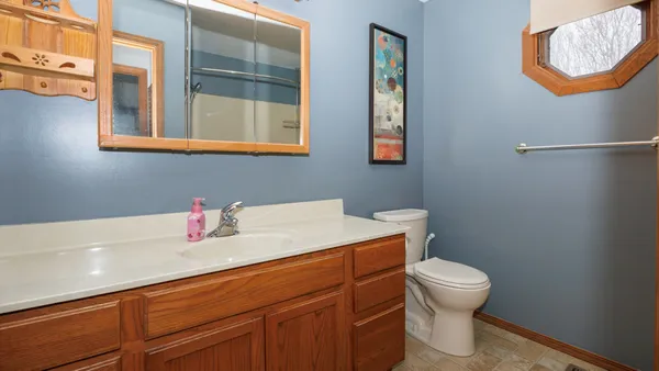 a view of a storage room with water heater and racks on the wall