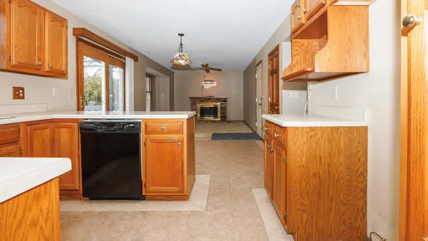 a kitchen with stainless steel appliances granite countertop a refrigerator and a stove