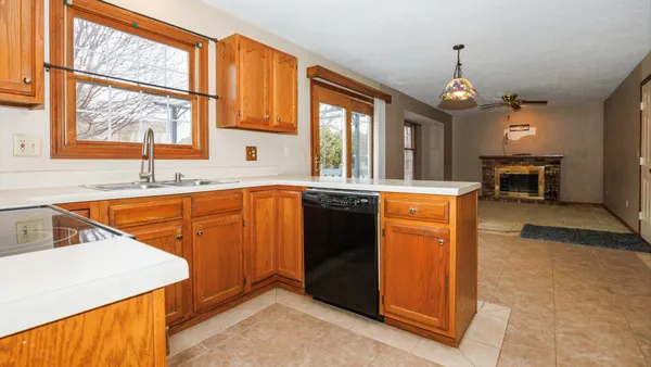 a kitchen that has a sink a stove and a microwave oven