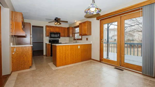 a view of a kitchen with a sink cabinet and windows