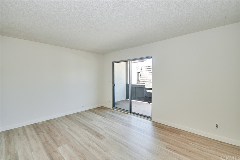 1140 Arcadia Avenue, Unit H Arcadia, CA 91007 - Photo 24 of 46 an empty room with wooden floor & windows