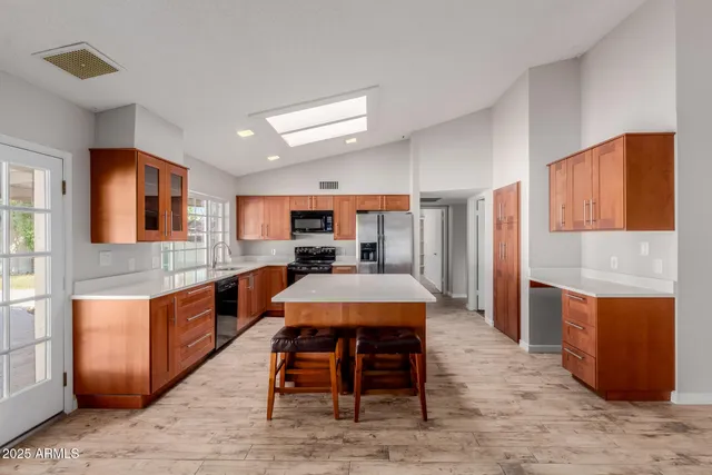 a large kitchen with a table and chairs in it