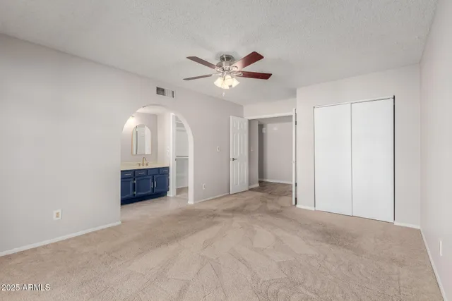 a view of a livingroom with a ceiling fan and window