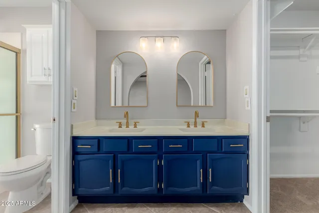 a bathroom with a double vanity sink and a mirror