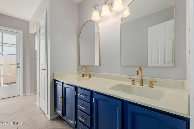 a bathroom with a double vanity sink and a mirror