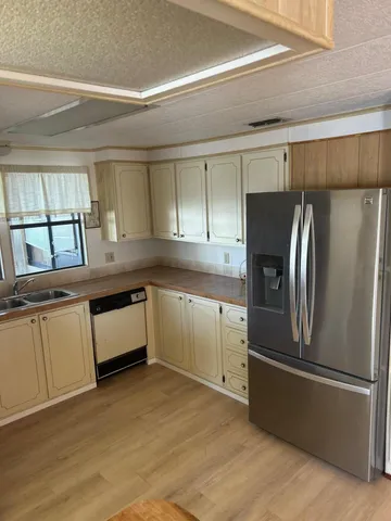 a kitchen with stainless steel appliances a refrigerator sink and cabinets