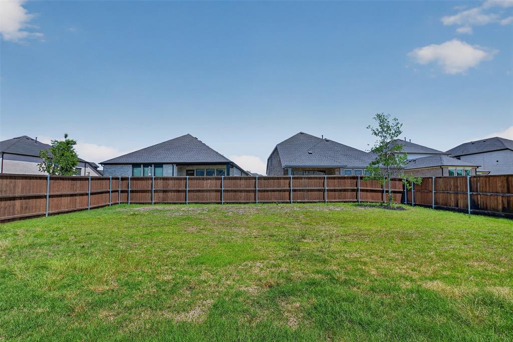 845 Ranchland Road Justin, TX 76247 - Photo 22 of 22 a view of a house with backyard and garden