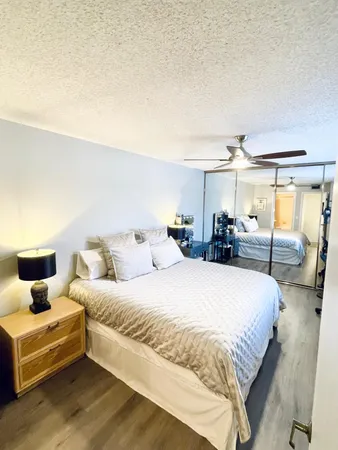a large bedroom with a bed and window