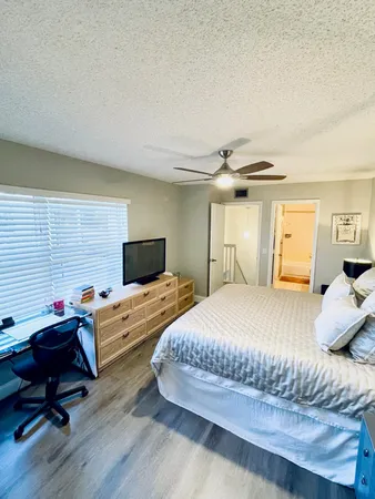 a bedroom with a bed and wooden floor