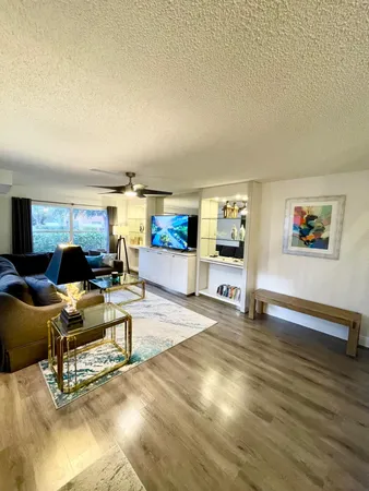 a living room with furniture and a wooden floor