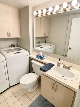 a bathroom with a sink a toilet and mirror