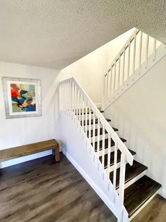 a view of staircase with lots of frames and wooden floor