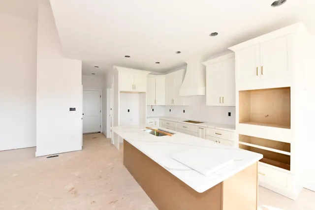 a view of a kitchen with a sink stove and cabinets