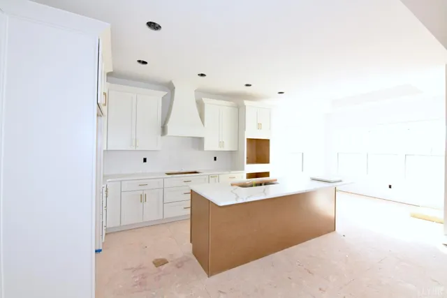 a kitchen with white cabinets and white appliances