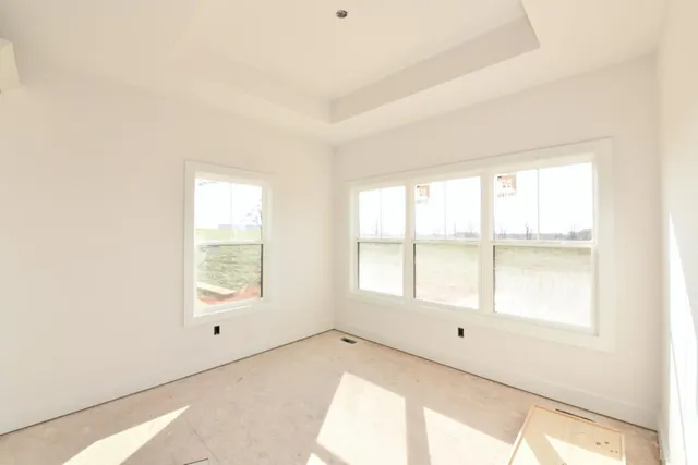 a view of an empty room and a window