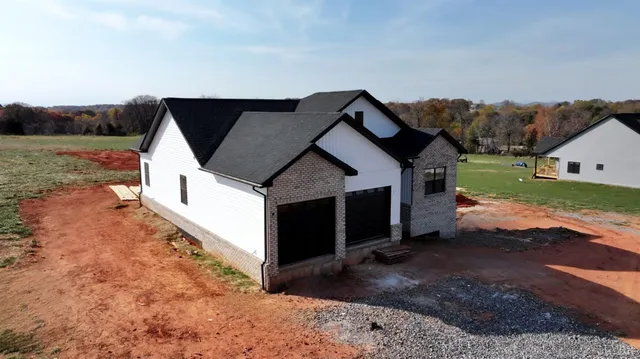 a view of house with backyard and garden