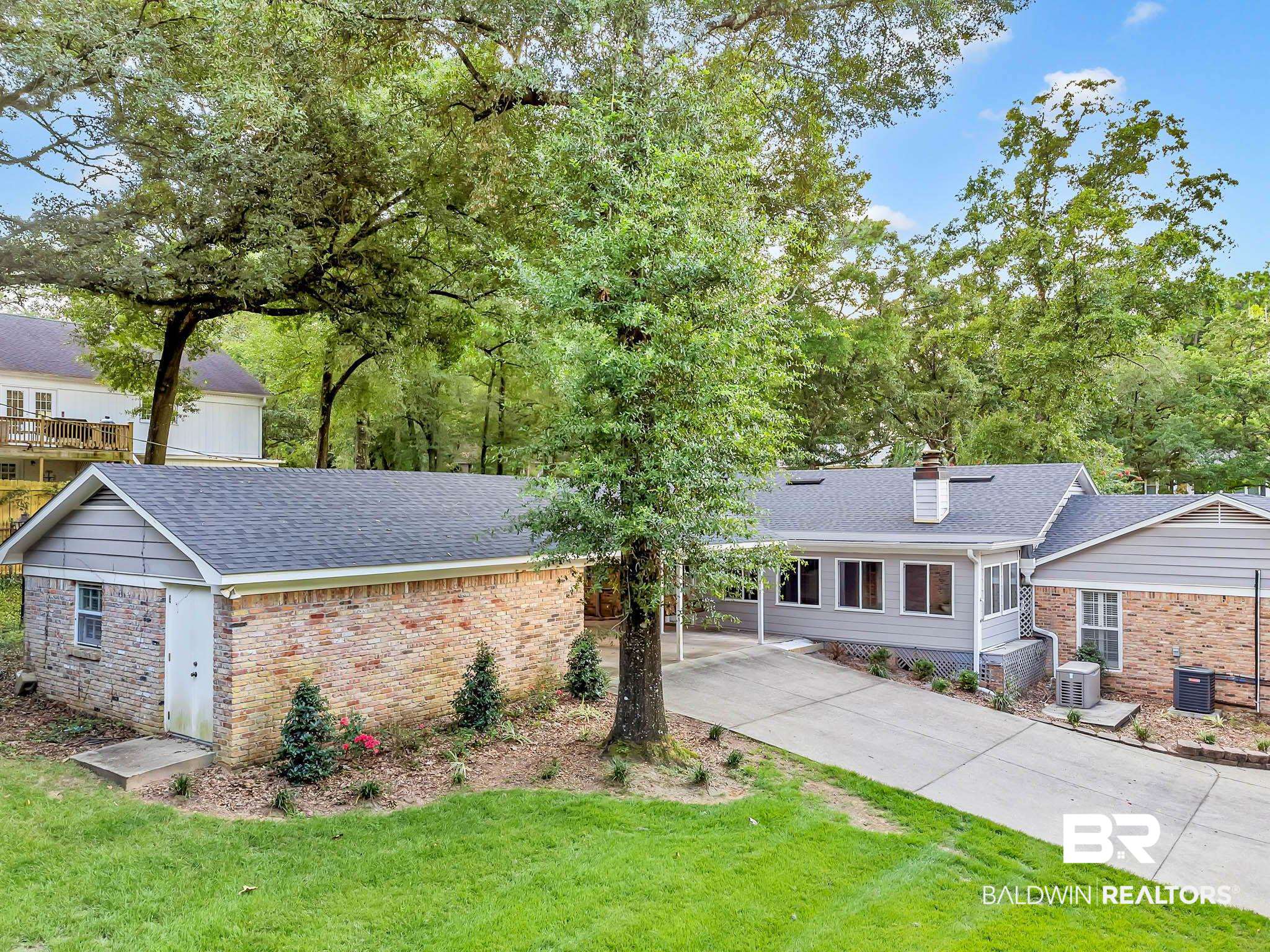 309 West Brandy Run Road Mobile, AL 36608 - Photo 97 of 100 Ranch-style house with a shingled roof, a front yard, concrete driveway, and a chimney