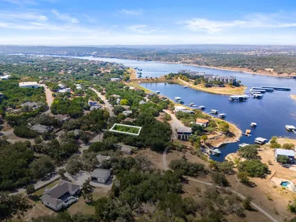 an aerial view of ocean and residential houses with outdoor space