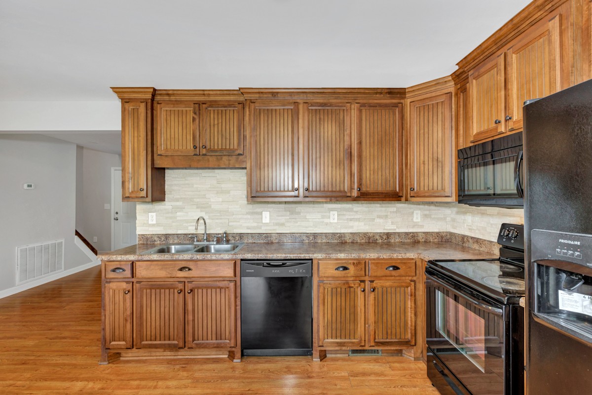 26939 Bethel Road Elkmont, AL 35620 - Photo 8 of 25 a kitchen with stainless steel appliances granite countertop a stove a sink and a microwave