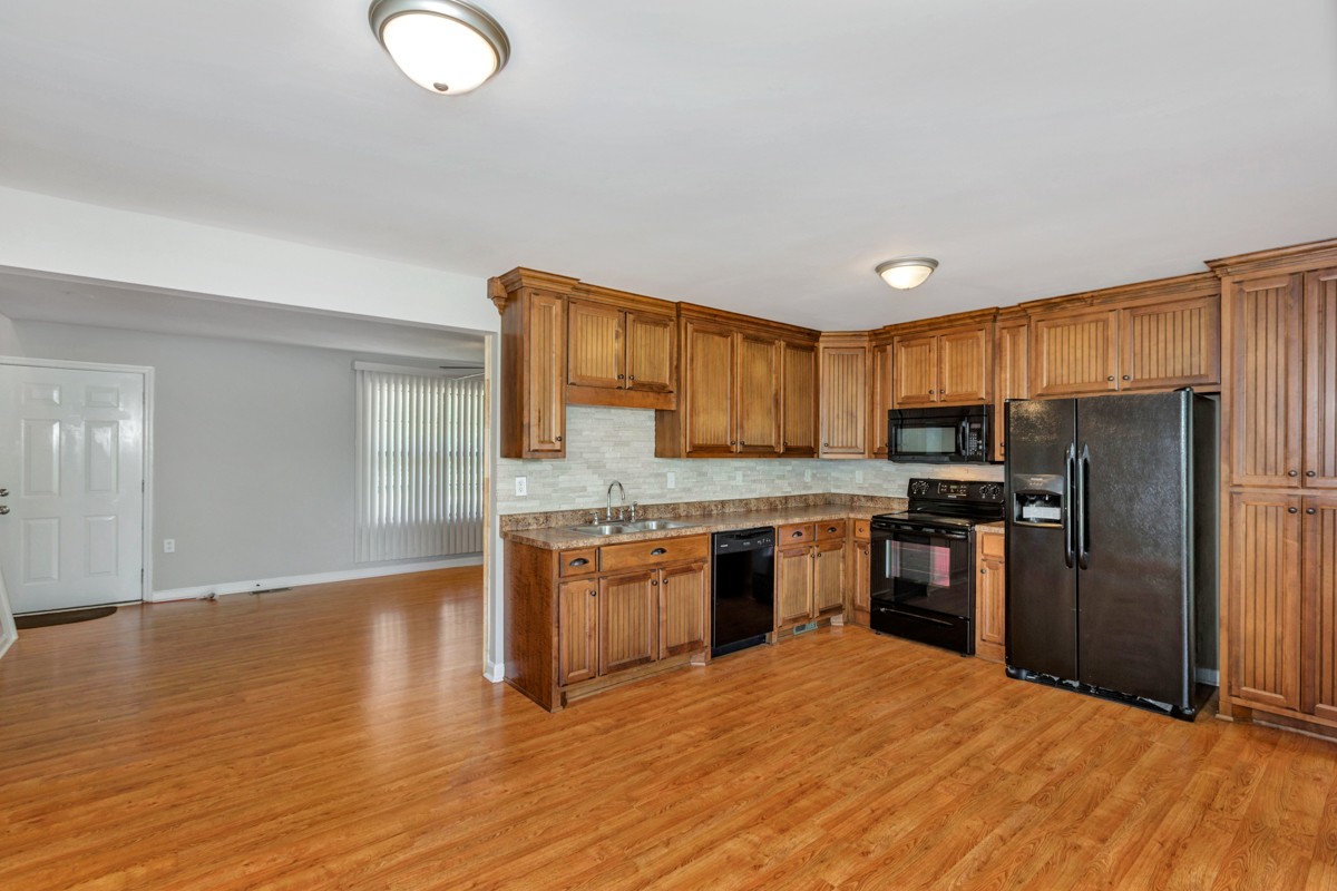 26939 Bethel Road Elkmont, AL 35620 - Photo 9 of 25 a kitchen with granite countertop a refrigerator stove top oven and sink