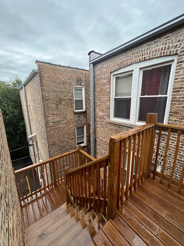 2052 East 68th Street, Unit 3 Chicago, IL 60649 - Photo 13 of 14 a view of a house with wooden deck