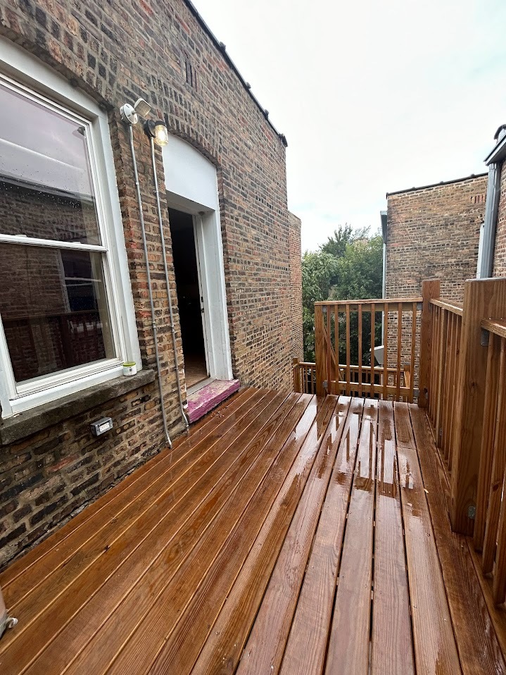 2052 East 68th Street, Unit 3 Chicago, IL 60649 - Photo 14 of 14 a view of balcony with wooden floor