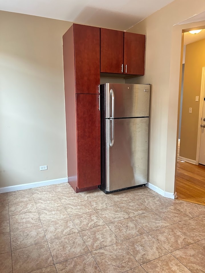2052 East 68th Street, Unit 3 Chicago, IL 60649 - Photo 7 of 14 a view of a kitchen with a refrigerator cabinets and a refrigerator