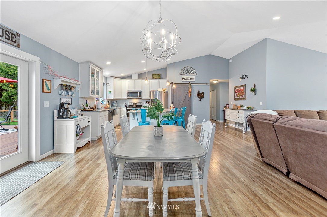 19614 Lerch Road Snohomish, WA 98290 - Photo 11 of 40 a living room with kitchen island furniture and a chandelier