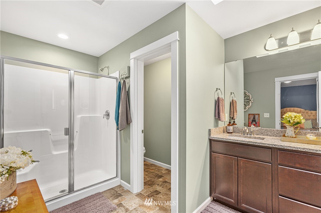 19614 Lerch Road Snohomish, WA 98290 - Photo 15 of 40 a bathroom with a shower sink and mirror