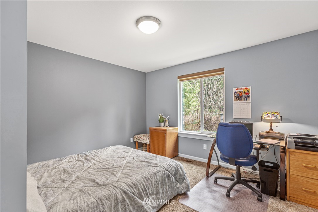 19614 Lerch Road Snohomish, WA 98290 - Photo 18 of 40 a bedroom with a bed and a window