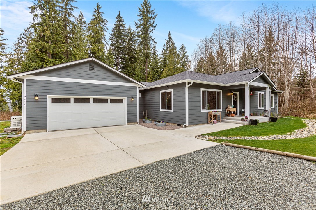19614 Lerch Road Snohomish, WA 98290 - Photo 24 of 40 a front view of a house with a yard and garage