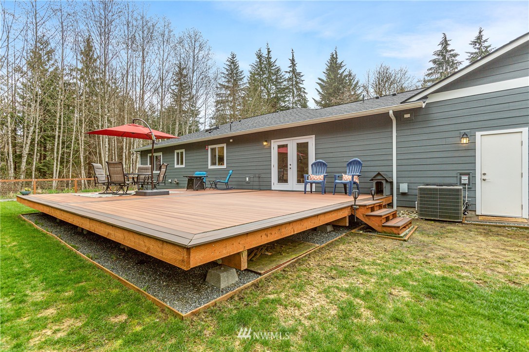 19614 Lerch Road Snohomish, WA 98290 - Photo 28 of 40 a view of a patio with a table and chairs under an umbrella