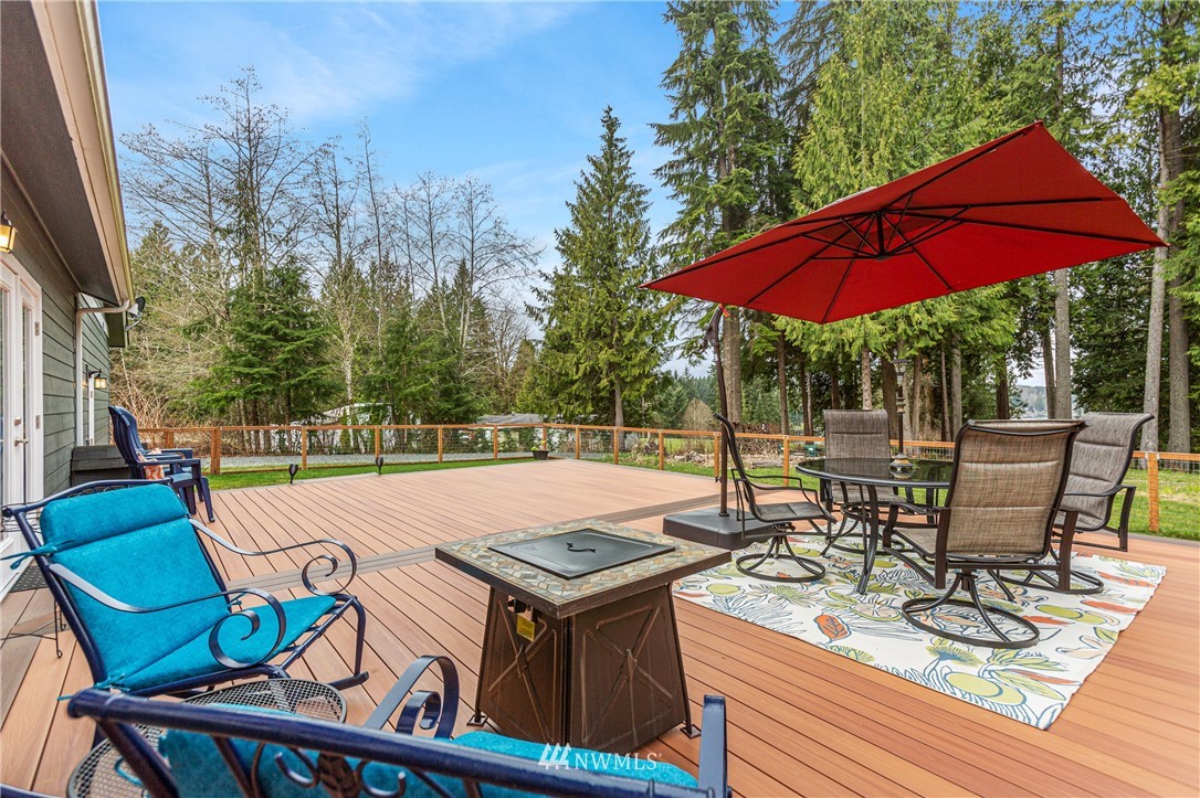 19614 Lerch Road Snohomish, WA 98290 - Photo 29 of 40 a view of a patio with table and chairs under an umbrella