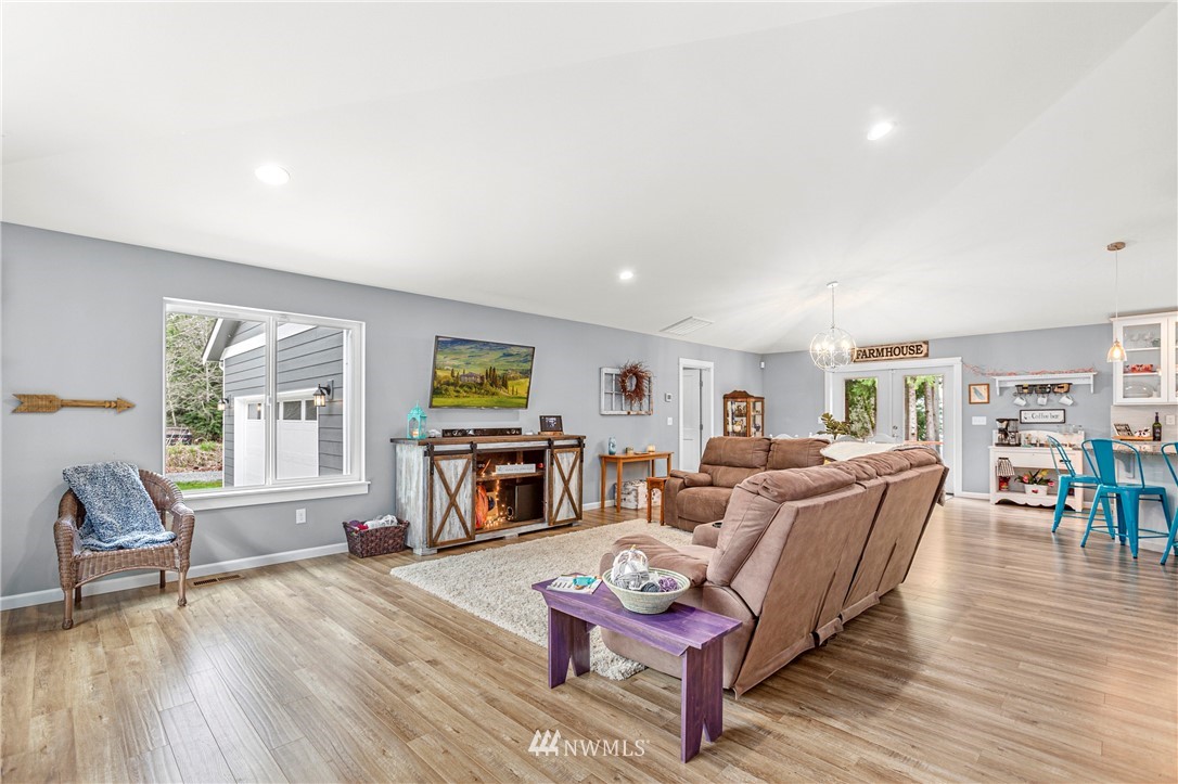 19614 Lerch Road Snohomish, WA 98290 - Photo 4 of 40 a living room with furniture and a fireplace with wooden floor