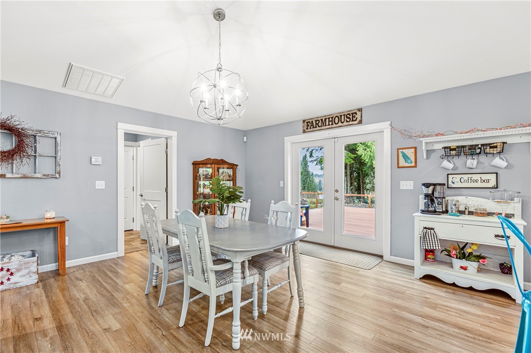 19614 Lerch Road Snohomish, WA 98290 - Photo 5 of 40 a view of a dining room with furniture a chandelier and wooden floor